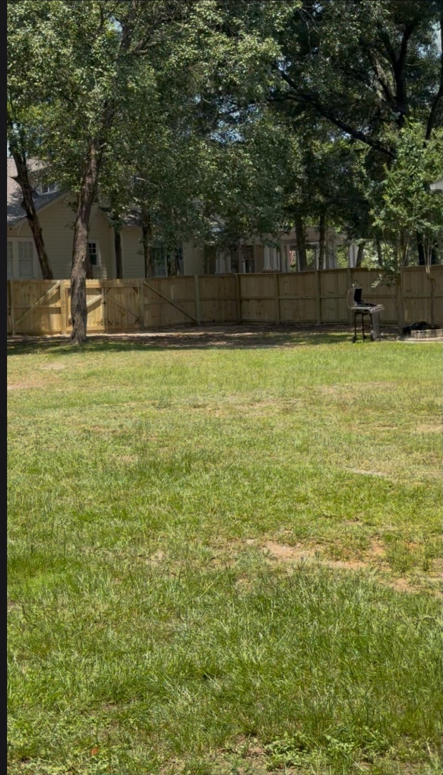 Wood privacy fence with a double-drive gate
