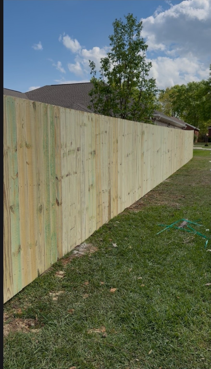 Long run of newly installed wood privacy fencing